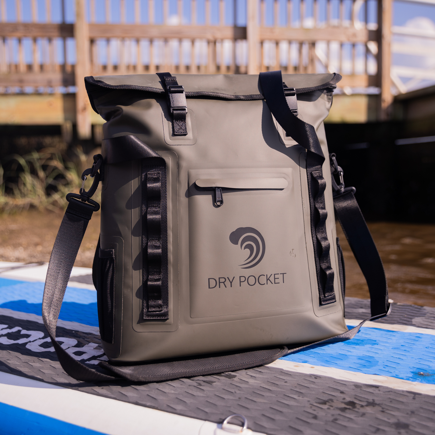 Waterproof floating tote cooler front view with dry pocket logo on tan waterproof fabric