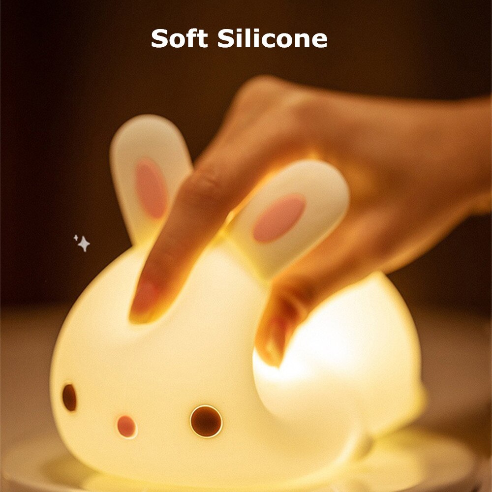 Glowing white bunny night light, soft silicone body with hand near the ear lights