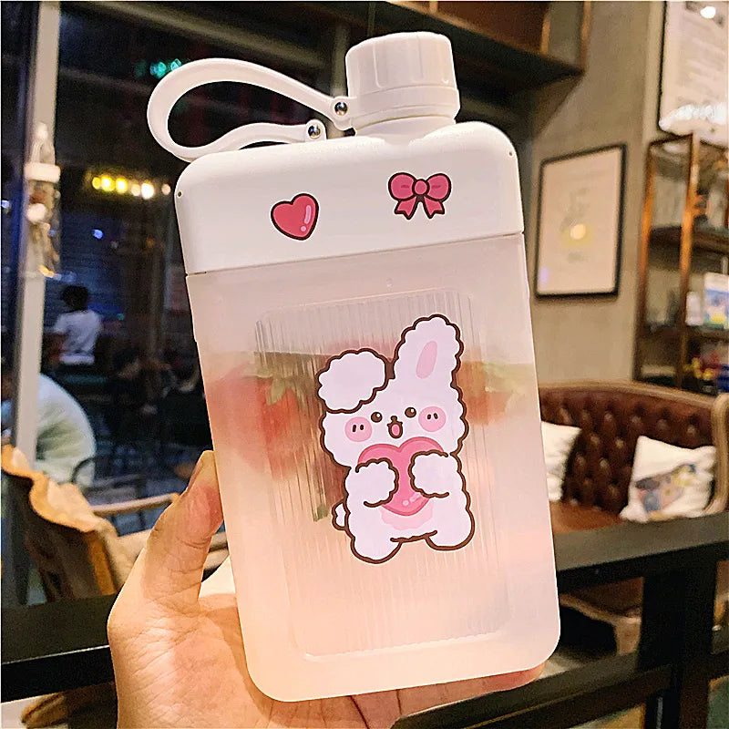 White flat water bottle with bunny sticker, pink heart and bow icons, carry loop and flip lid