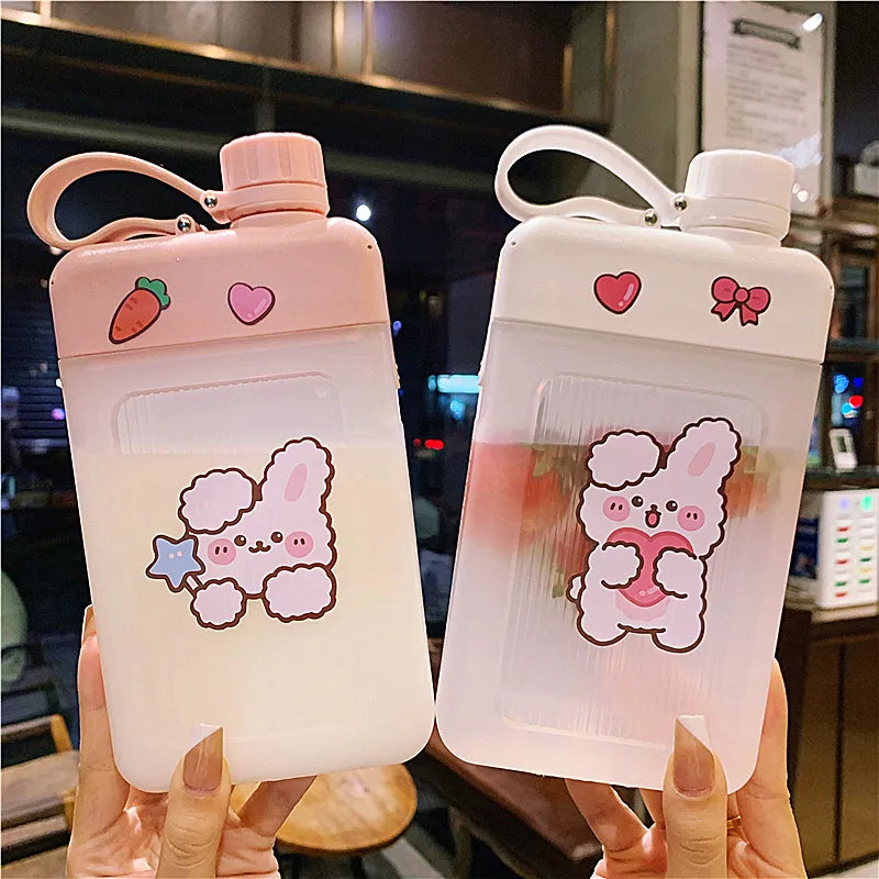 Pink flat water bottle with bunny and bear stickers, carry loop handle and flip lid