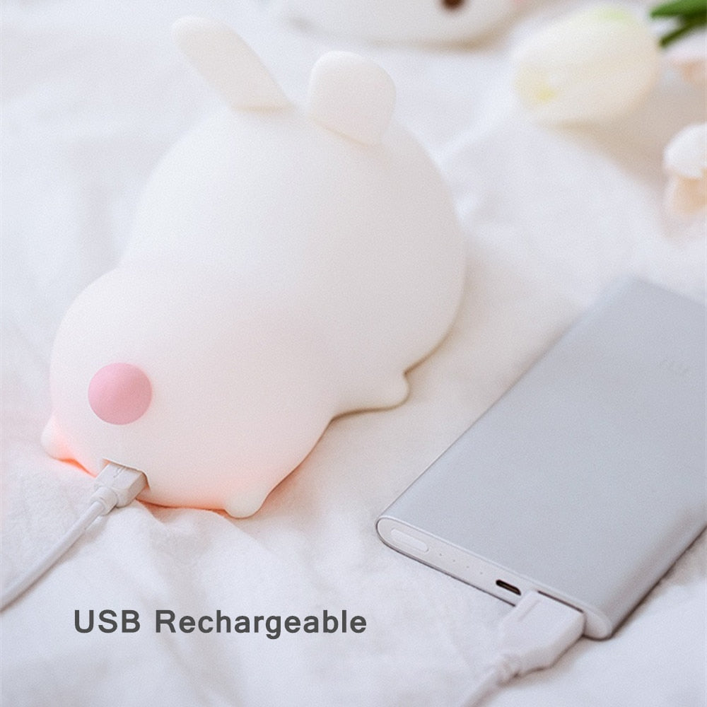 White bunny night light with USB charging cable, soft glow on the silicone face