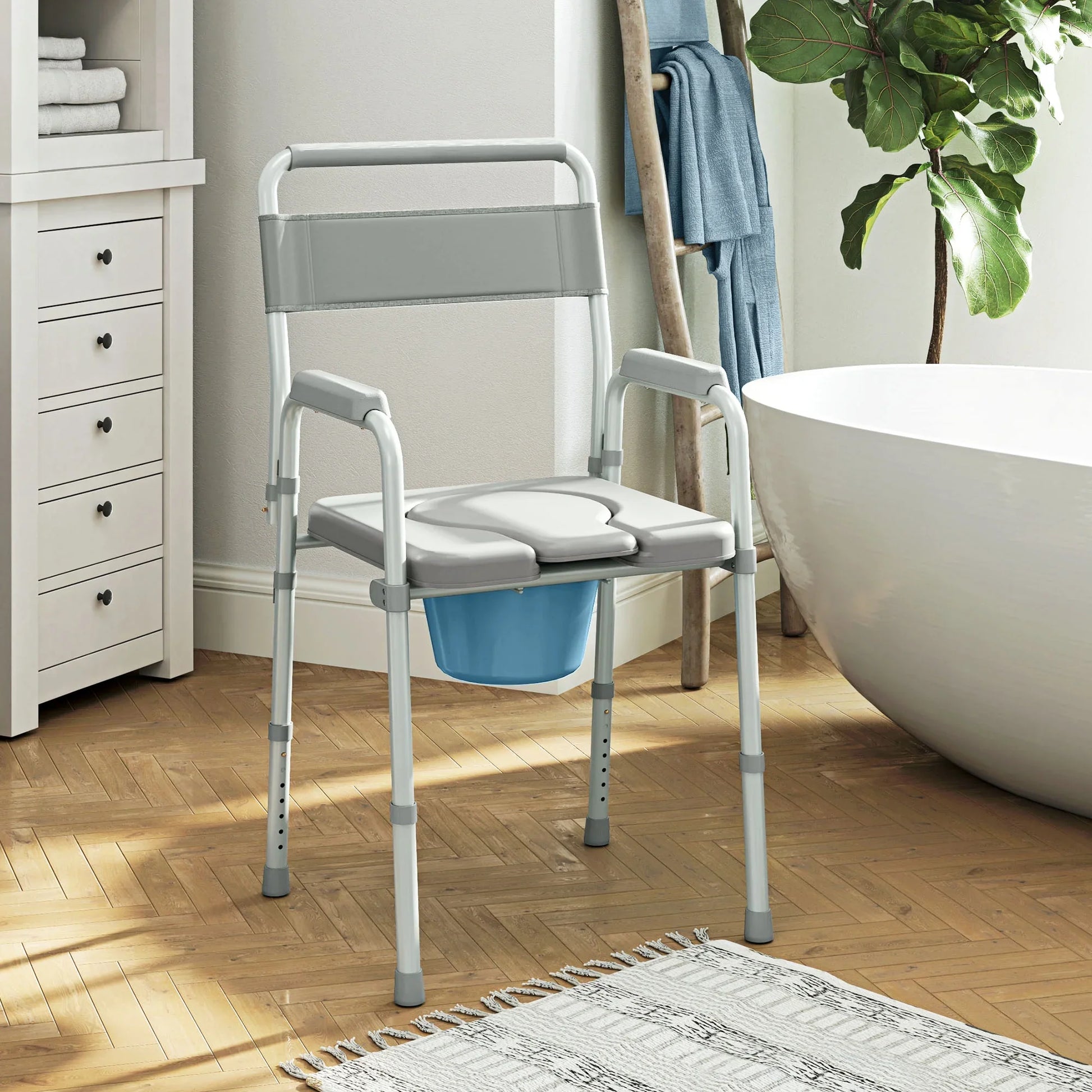 Adult bedside commode chair with gray seat and back, padded armrests, and blue waste bucket
