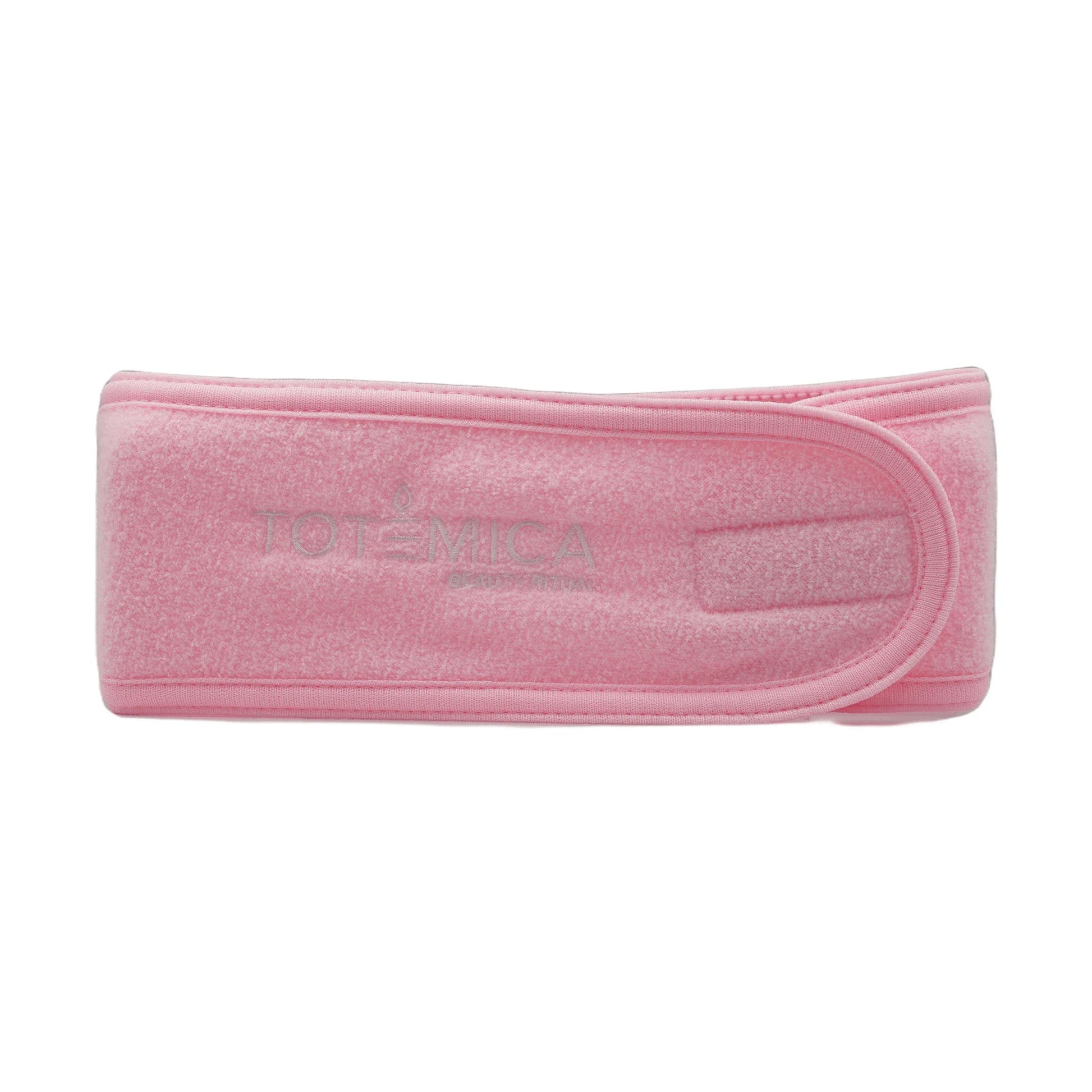 Pink spa headband with Totemica logo, terry texture, adjustable fit