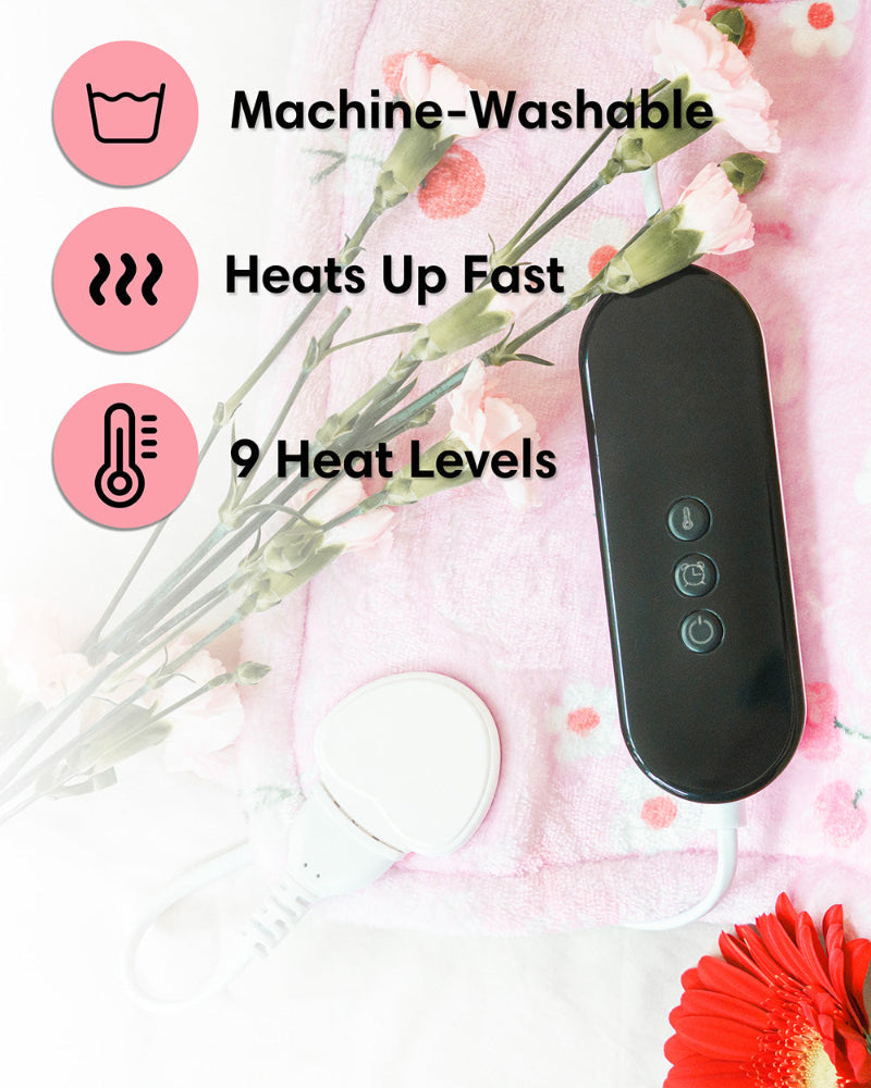 Pink cherry-print heating pad with black controller and cord on plush fabric