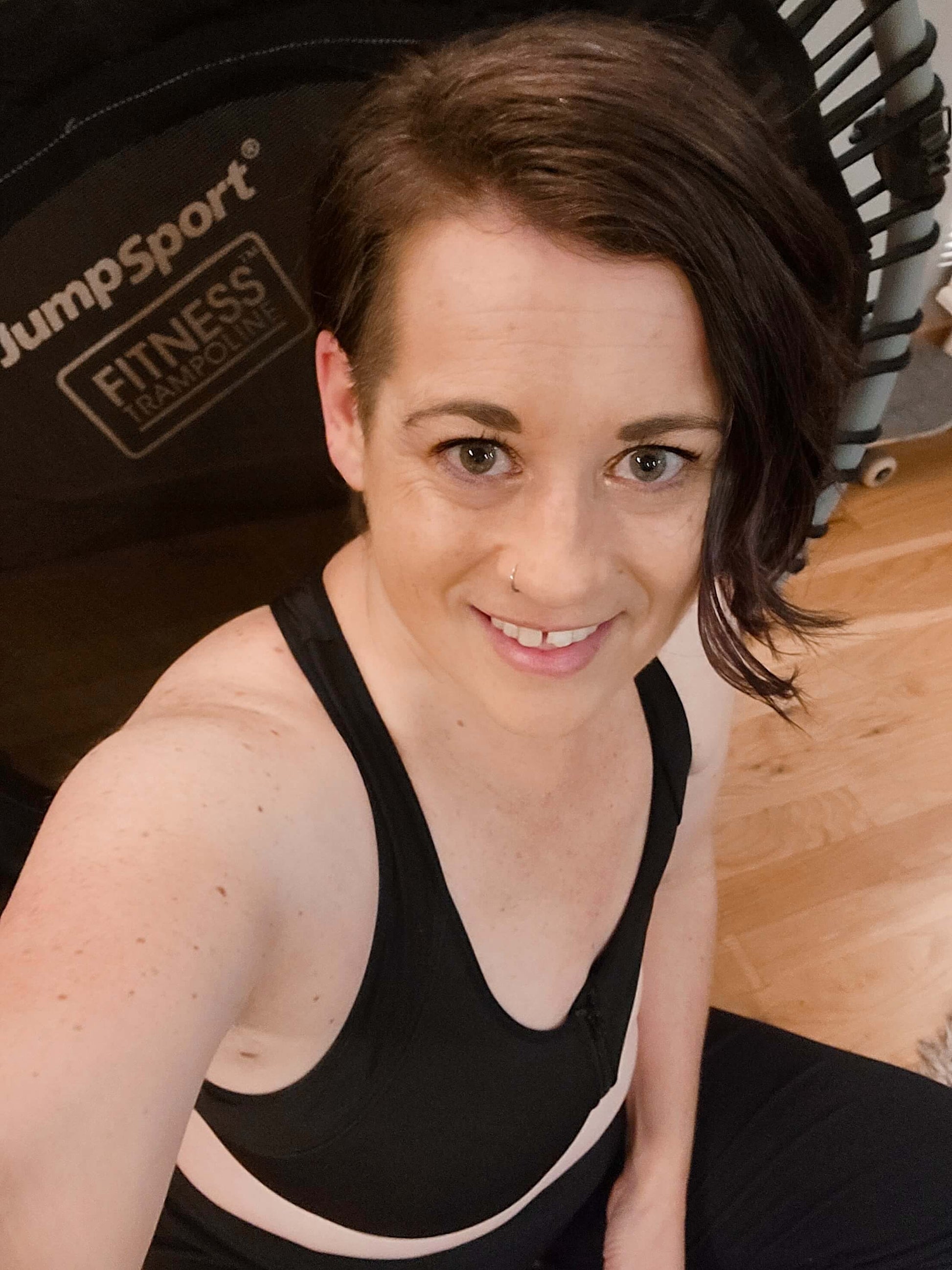 Black sports bra with front zipper seam and racerback straps, close-up