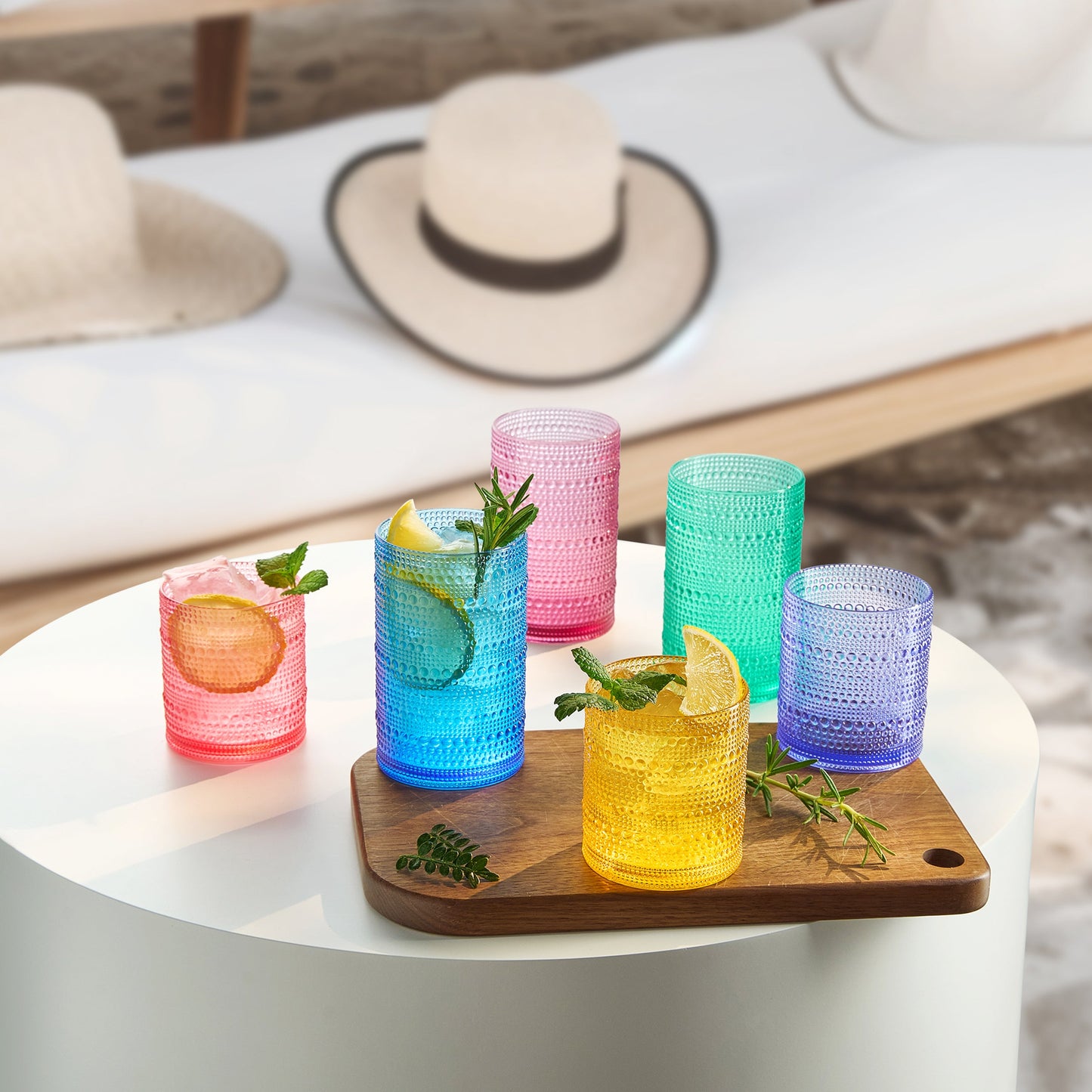 Multicolor acrylic hobnail tumblers, lowball/highball style, several cups on tray