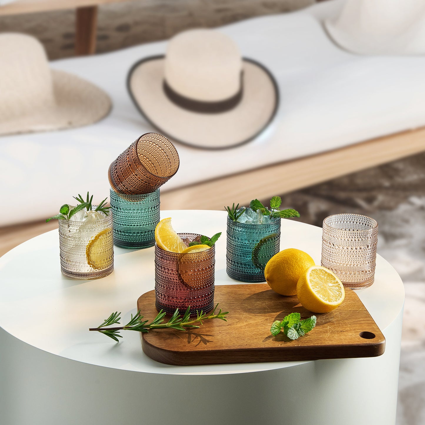Hobnail lowball glass tumblers in green, amber, and clear with ridged texture