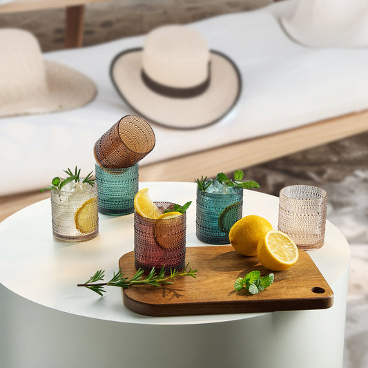 Hobnail lowball glass tumblers in green, amber, and clear with ridged texture