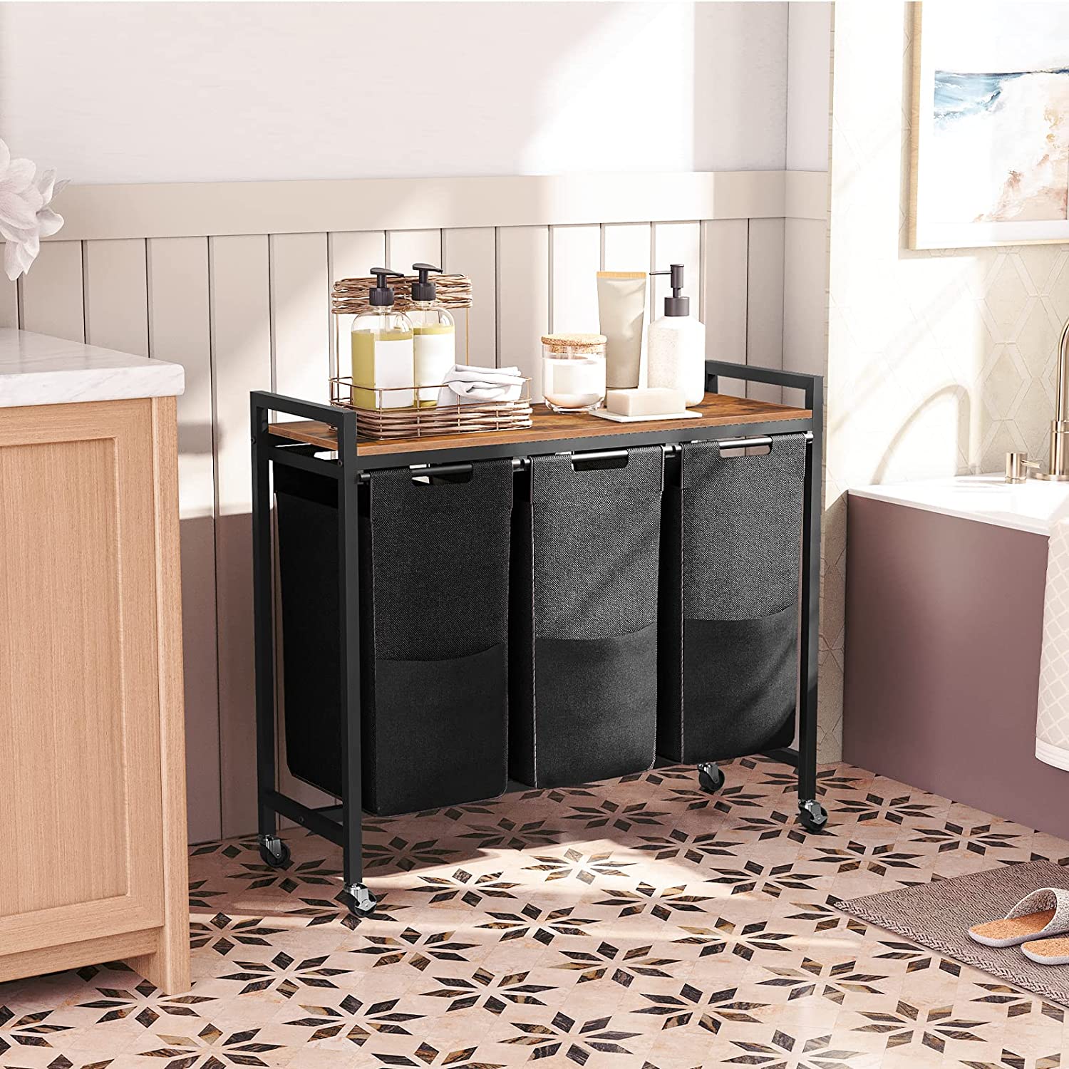 Rolling 3-compartment laundry sorter cart with dark fabric bins and wooden top shelf.
