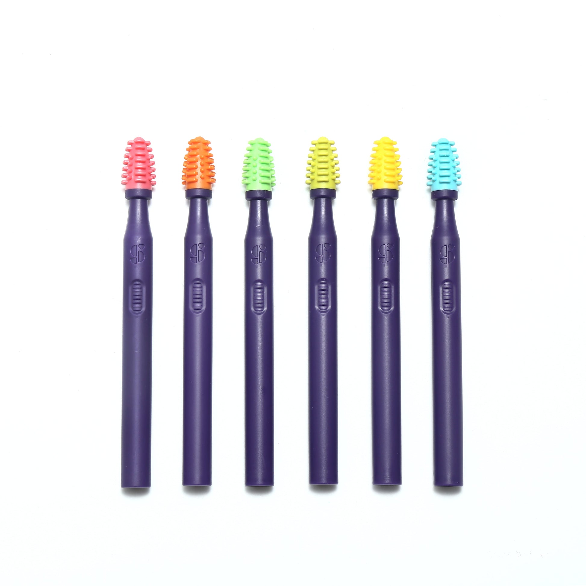Silicone oral stimulation brushes with textured bristles on purple handles, assorted colors
