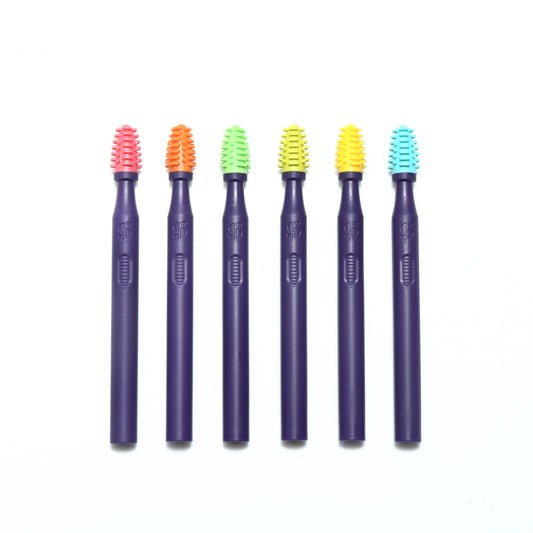 Silicone oral stimulation brushes with textured bristles on purple handles, assorted colors
