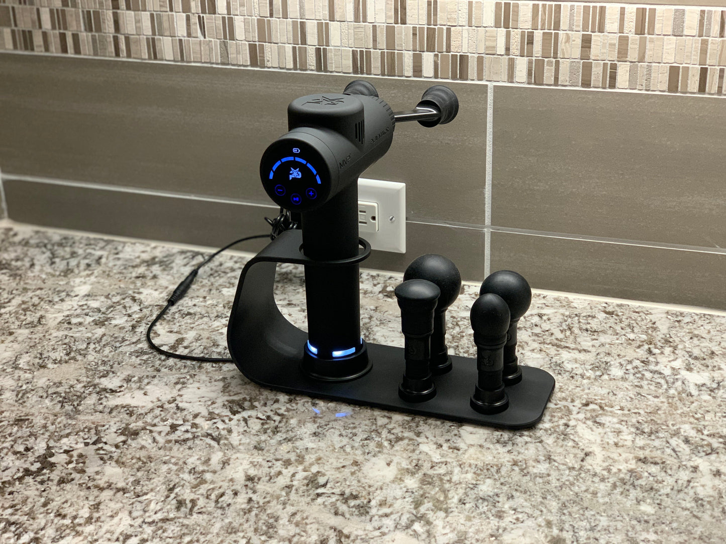 Black charging station with power base and four attachment heads on countertop