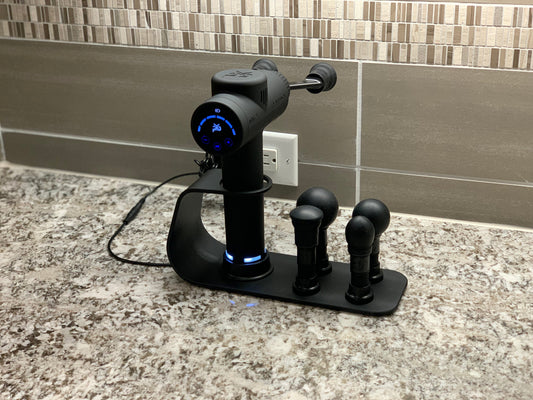 Black charging station with power base and four attachment heads on countertop