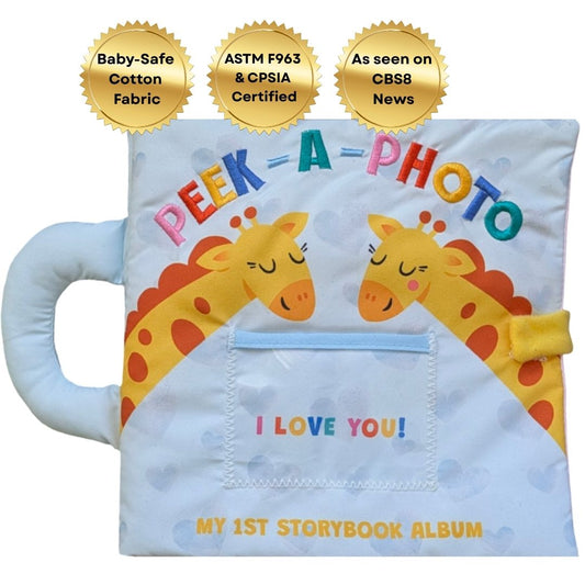 Soft cloth storybook album with Peek-A-Photo text, giraffe illustrations, and “I LOVE YOU!”