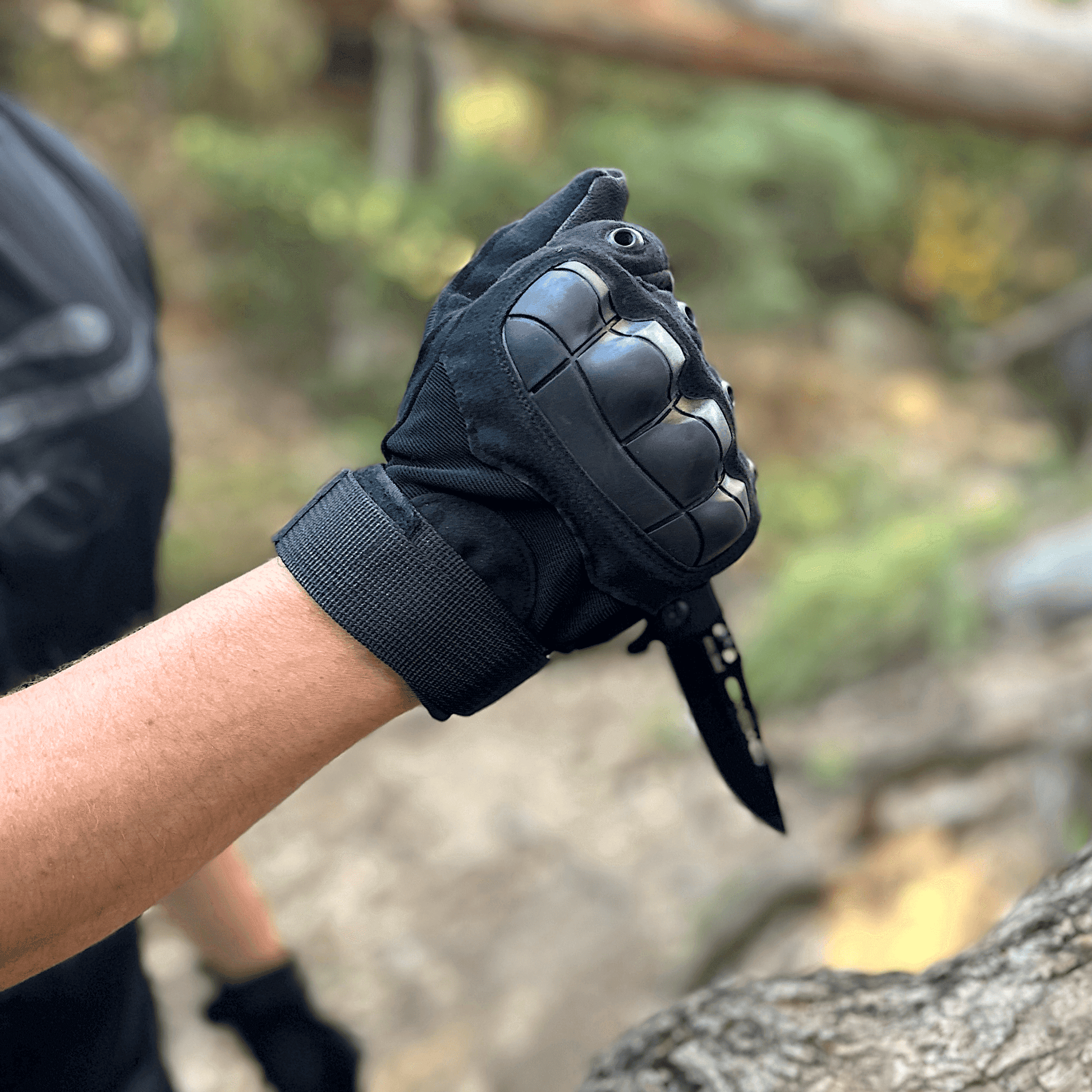 Black tactical glove with molded knuckle pads and grippy finger and palm texture