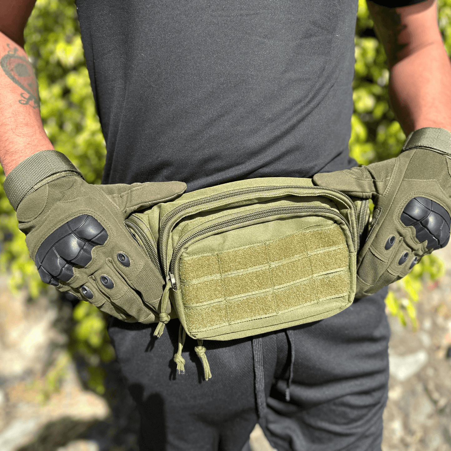 Tan tactical gloves with black knuckle pads and a front utility pouch on the belt pack.
