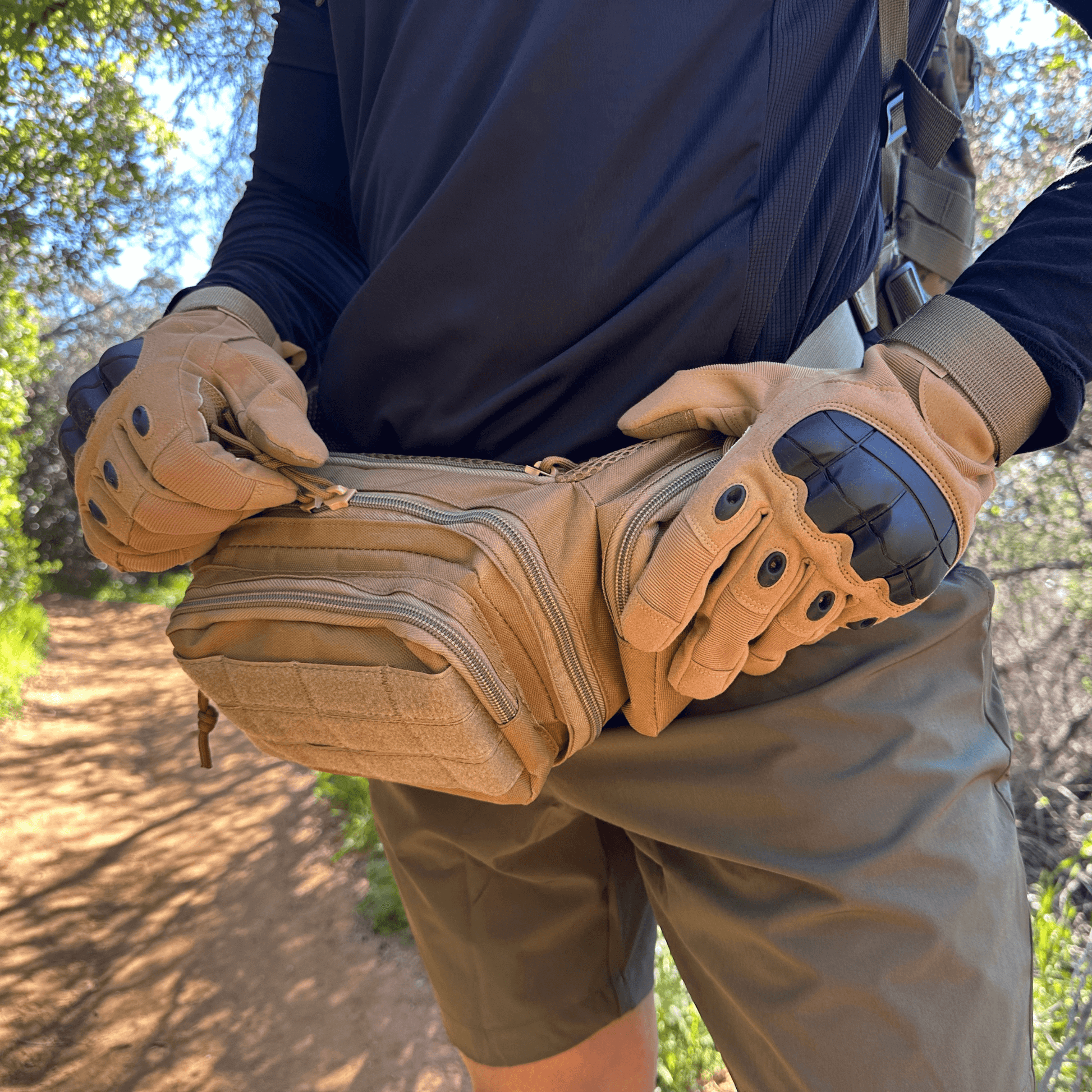 Tan tactical gloves and knuckle armor visible while holding a gear pouch