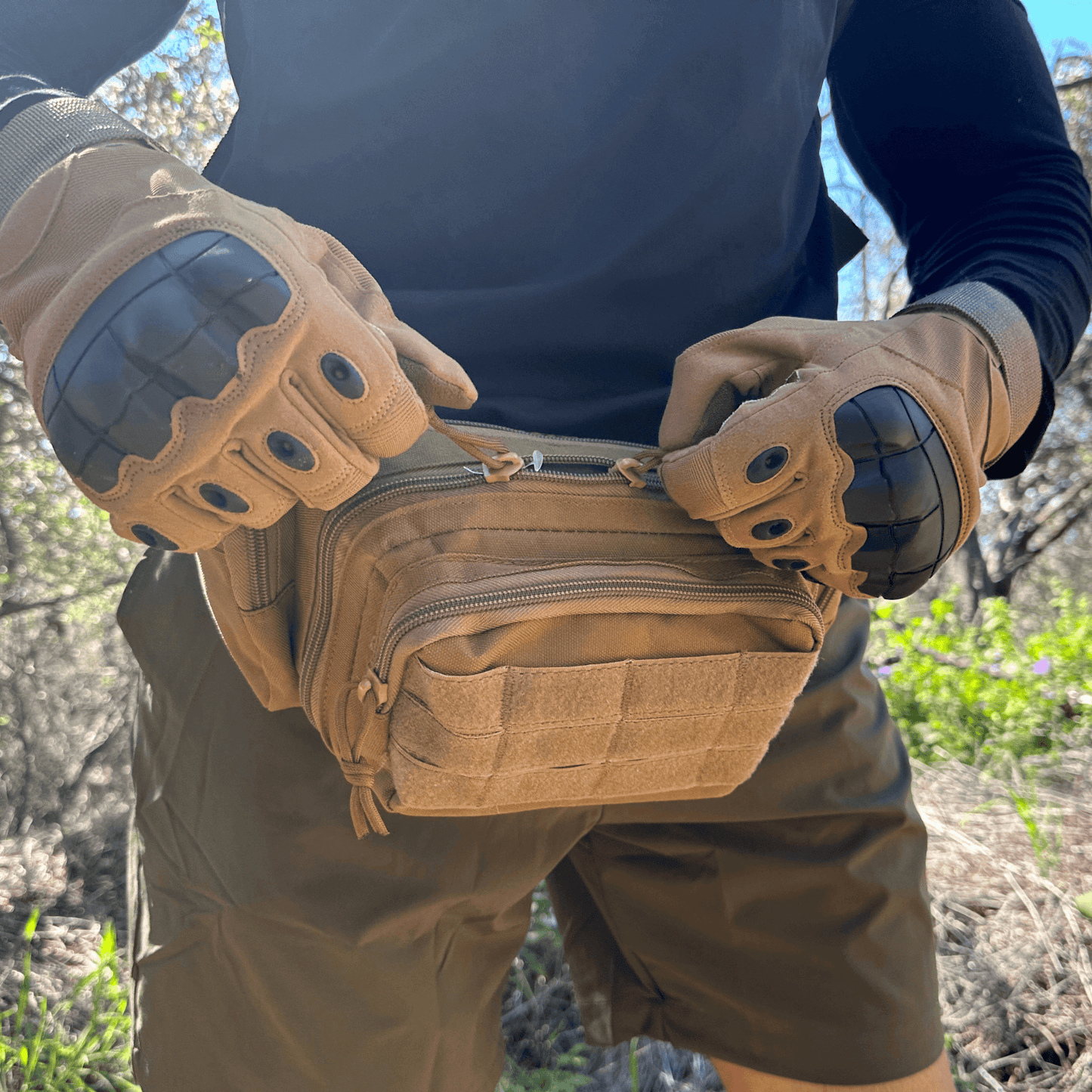 Close-up of tan tactical gloves with knuckle armor and padded palm seams