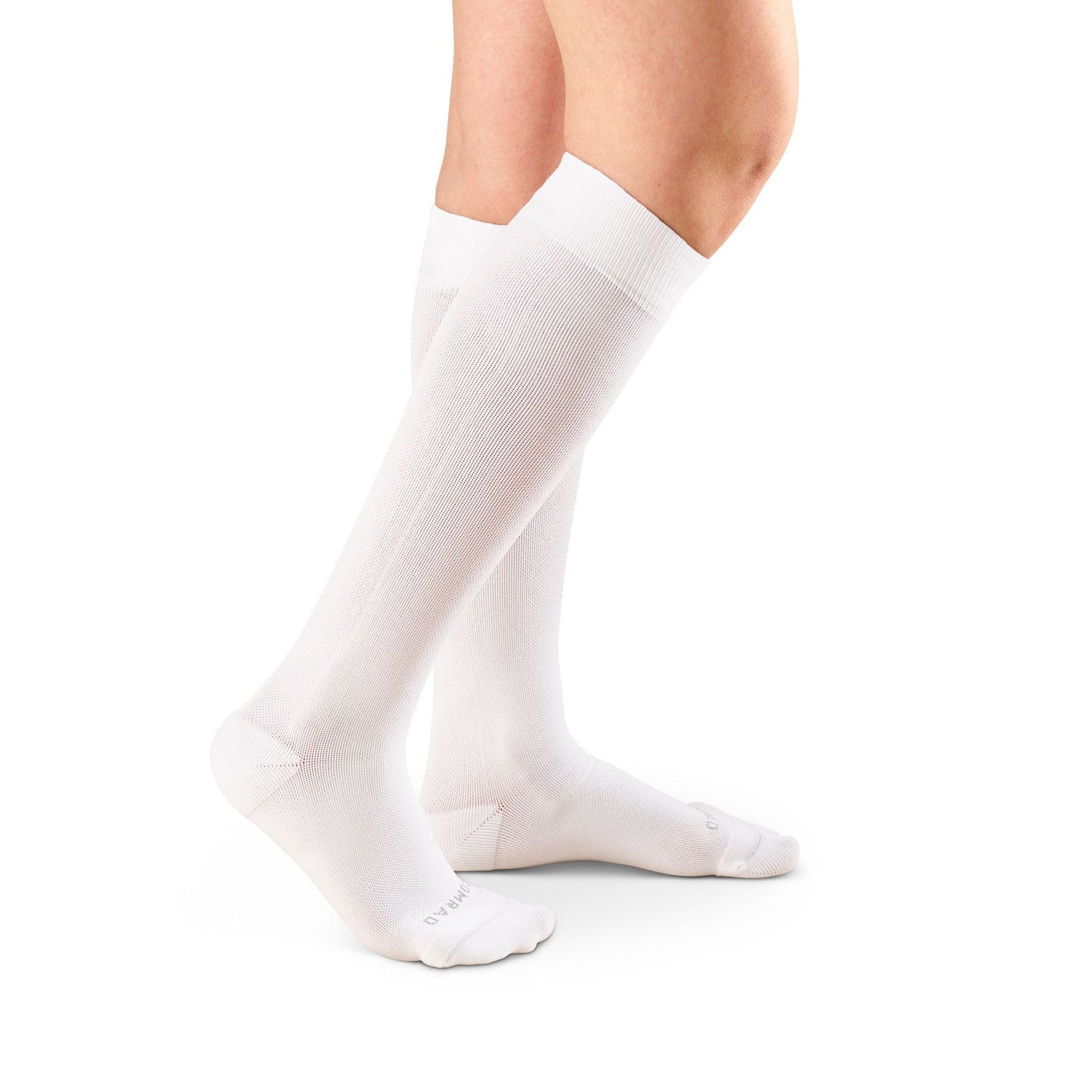 Knee-high compression socks in white on feet, smooth knit with reinforced toe