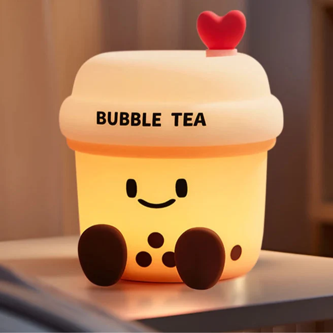 Kawaii bubble tea cup night light with glowing face, heart lid, and three dark topping dots.
