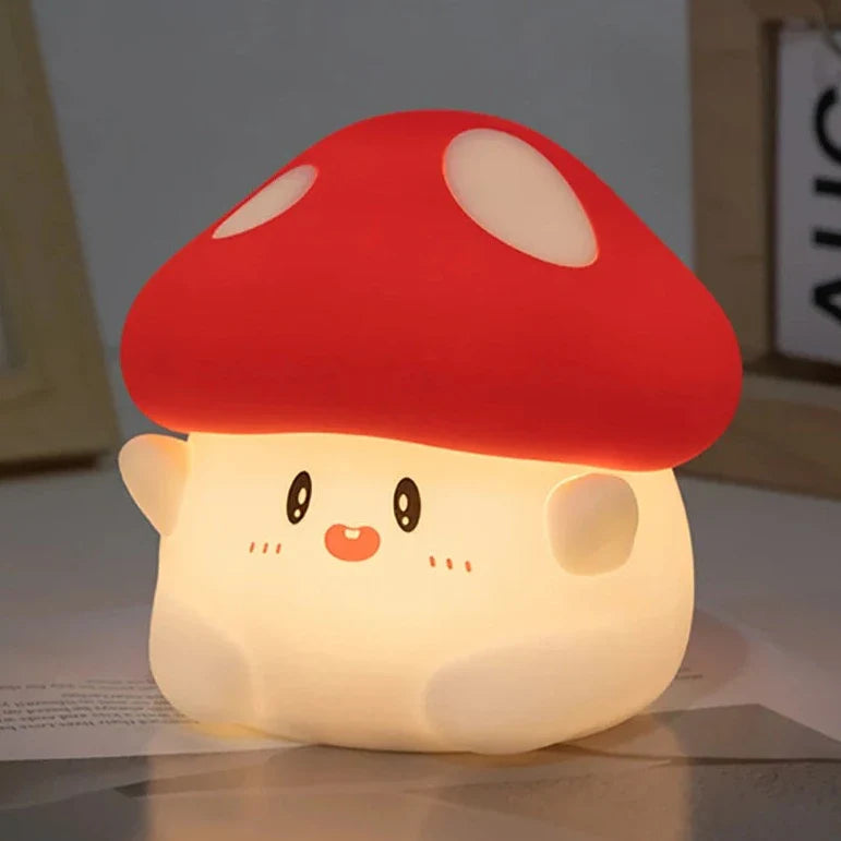 Red mushroom-shaped night light with glowing cream body and cute face