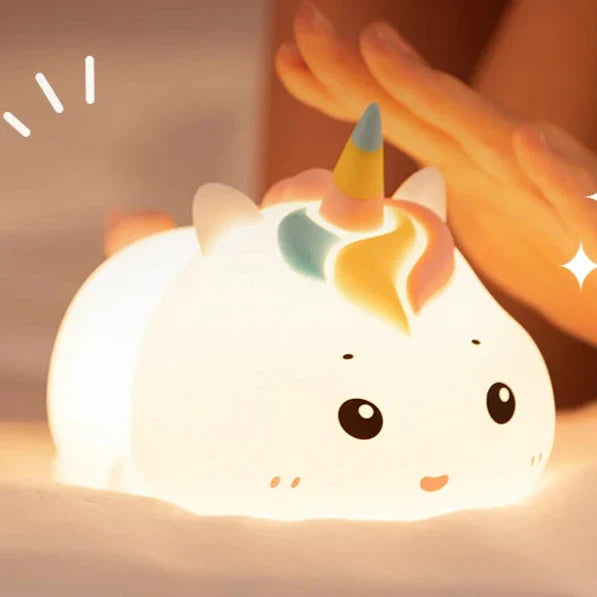 Glowing unicorn night light with horn and smiling face, soft warm light.