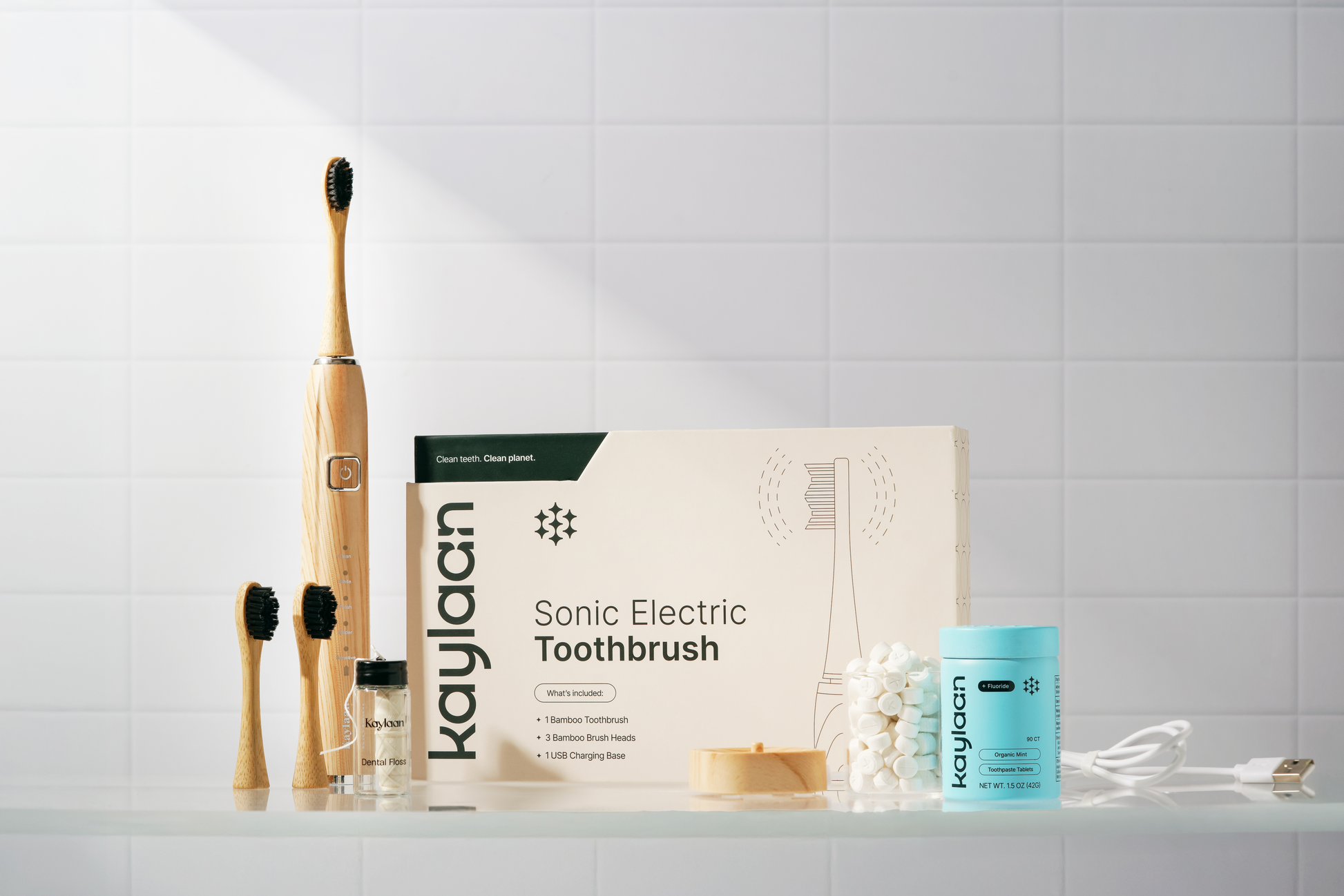 Bamboo electric toothbrush kit with wooden handle, black bristle head, box, and stand