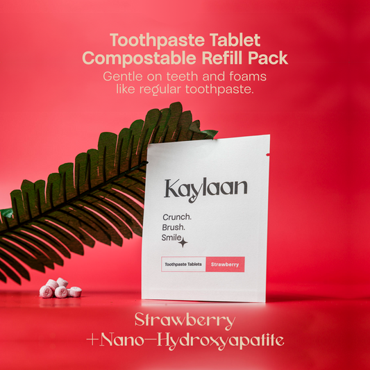 Strawberry toothpaste tablet refill pouch with scattered tablet pieces