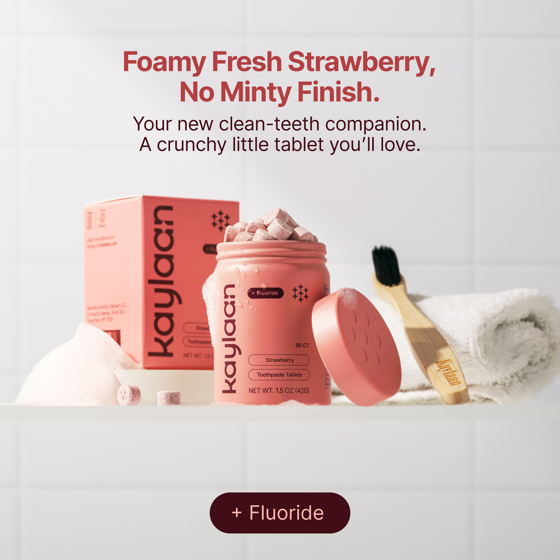 Fluoride strawberry toothpaste tablets with pink container, refill box, and toothbrush