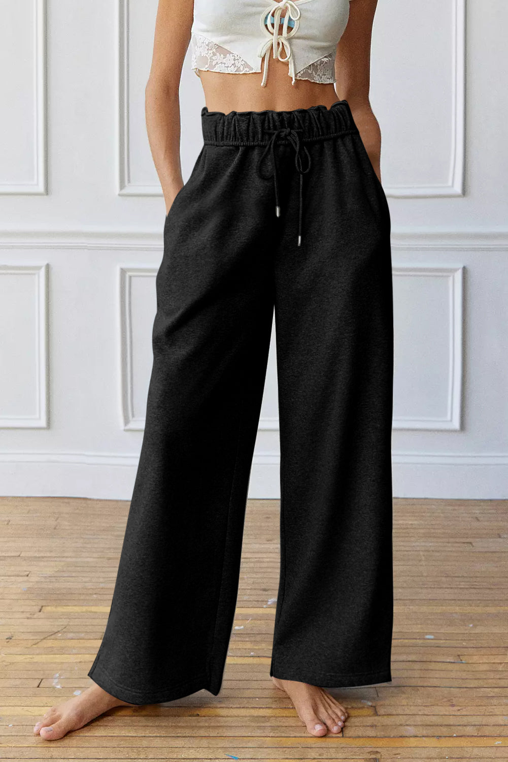 Black high-waist drawstring sweatpants with elastic waistband, wide leg, front view