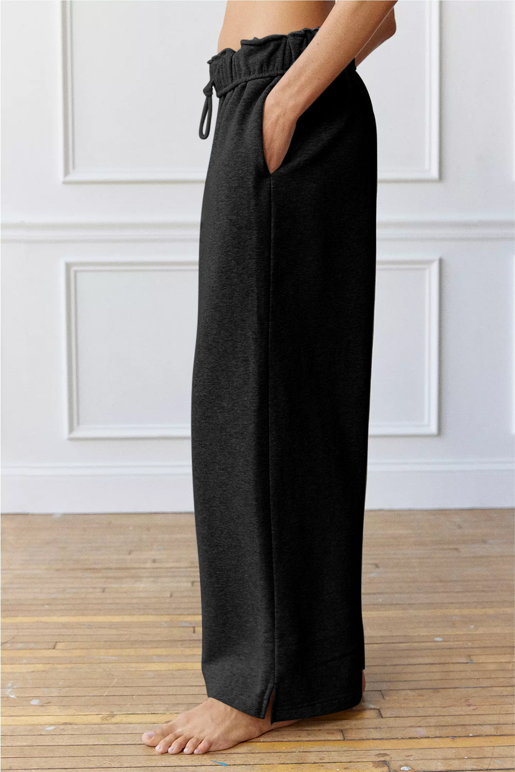 Black high-waist drawstring sweatpants with elastic waistband, ankle-length wide legs