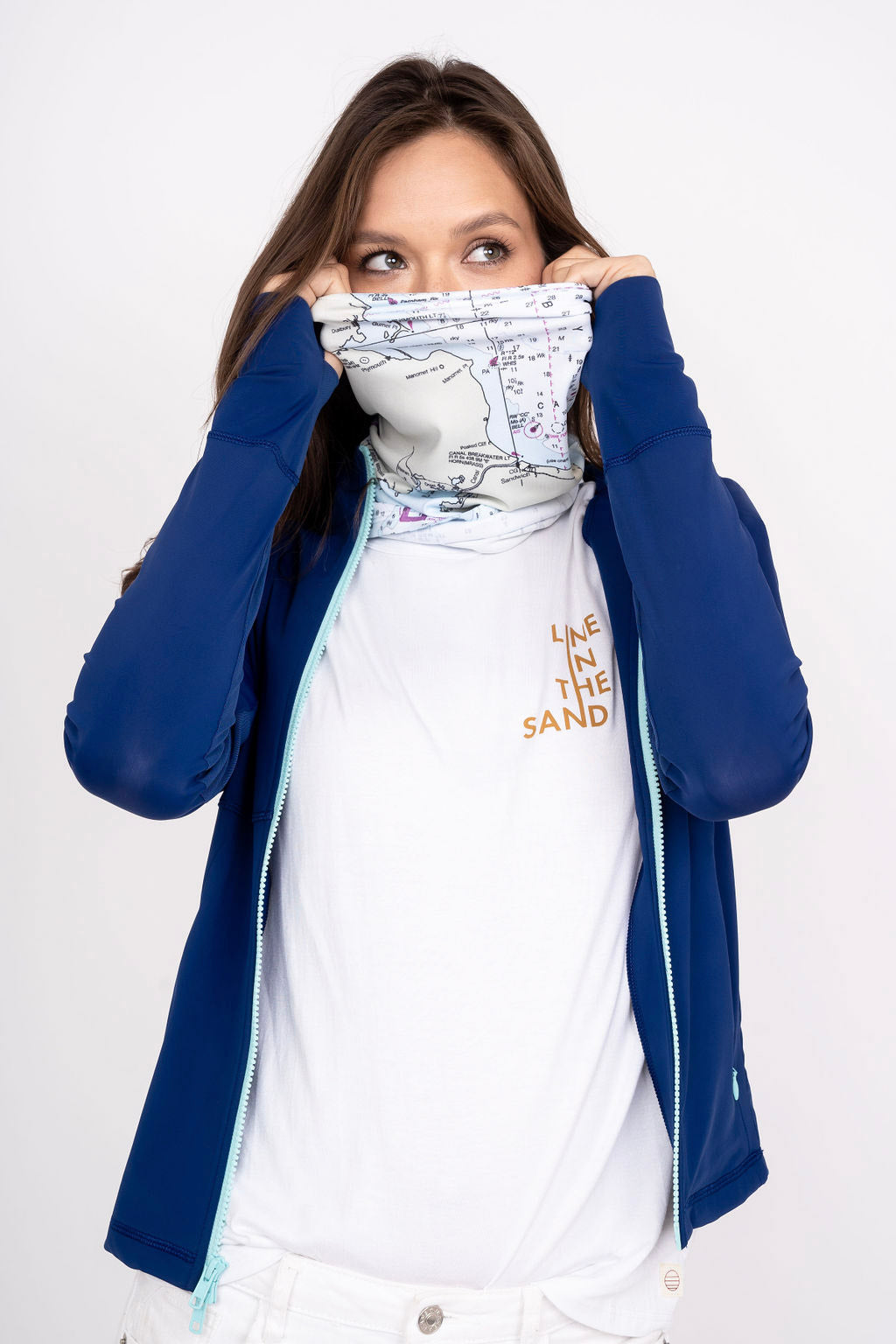 Solar gaiter with white map print and LINE THE SAND text, worn at neck