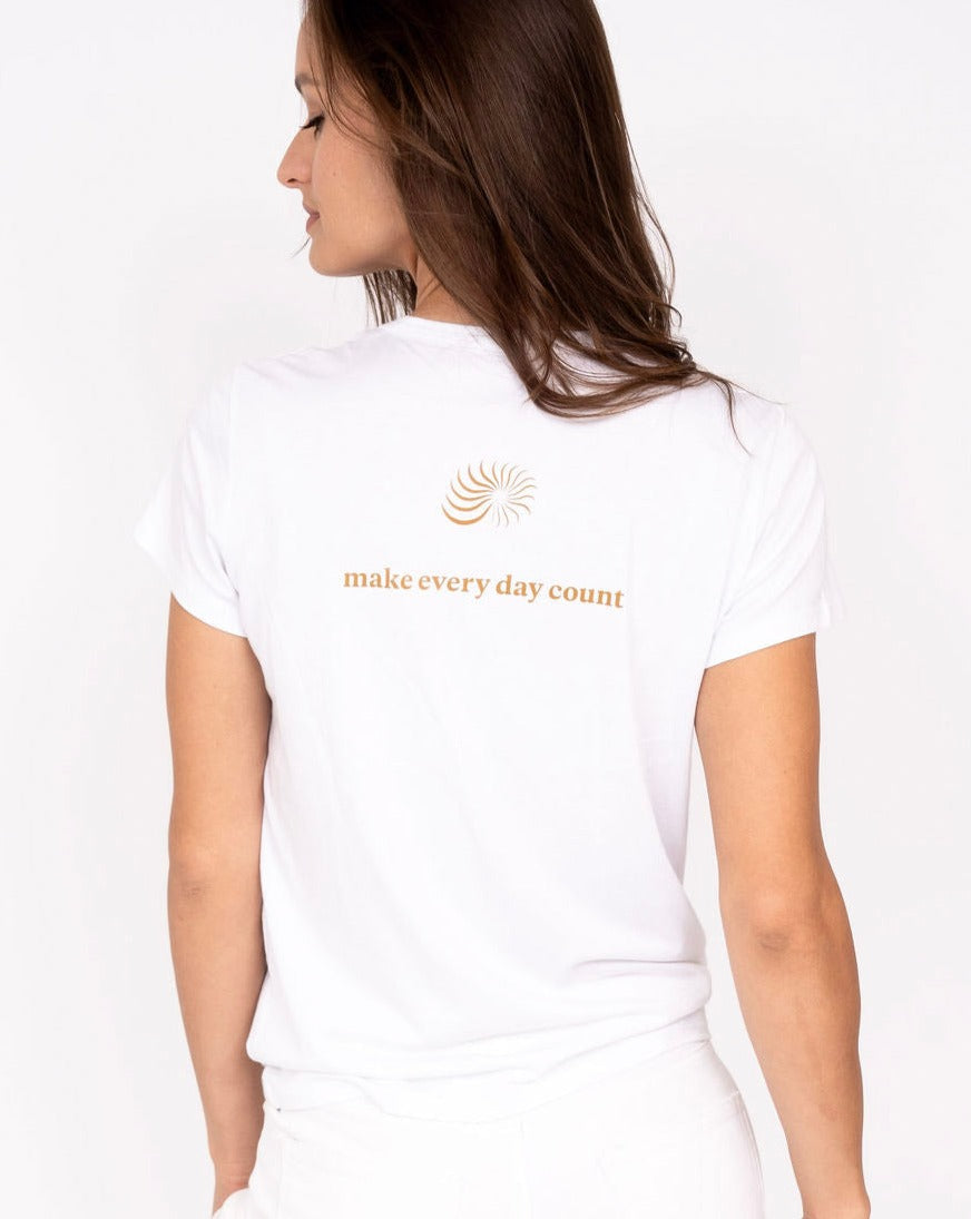 White crew-neck graphic tee with orange spiral emblem and 'make every day count' back print