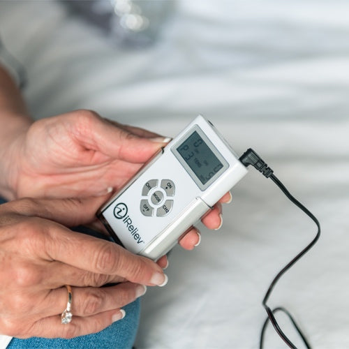 Handheld iReliev TENS controller with blue LCD and control buttons
