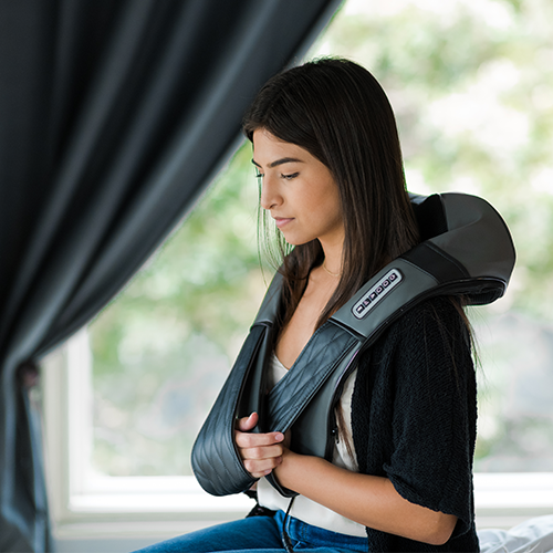 Shiatsu neck and back massager worn around a seated person’s neck and upper back