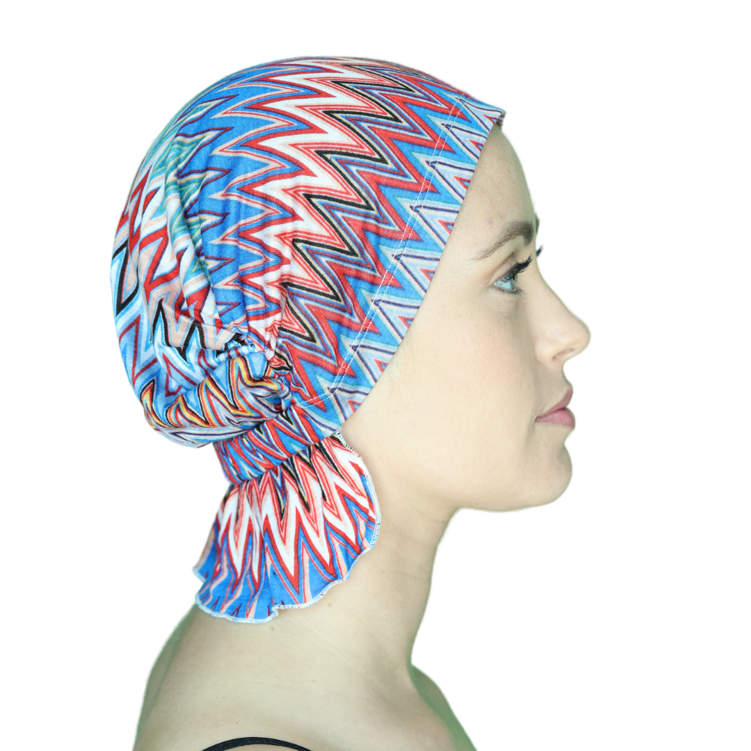 Chevron knit beanie with blue, red, and white zigzags, gathered side drape