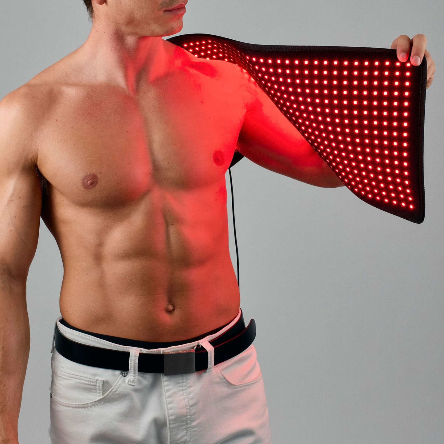 Lumara pad with red LED light panel held against the upper torso