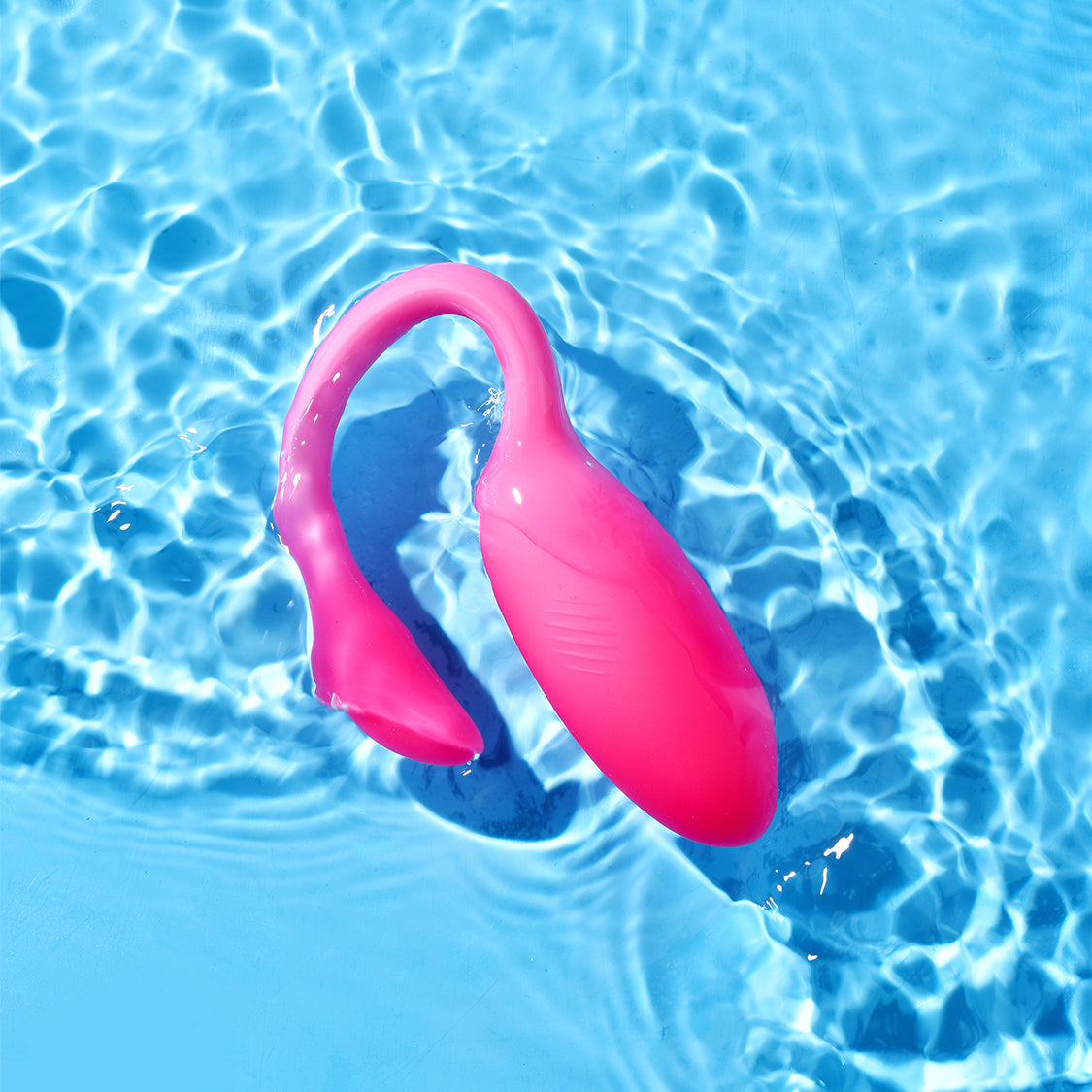 Pink flamingo-shaped personal massager floating in water