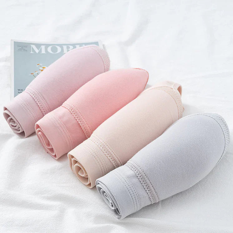 Folded nursing bra fabric in light pink, beige, and grey shown in rolls