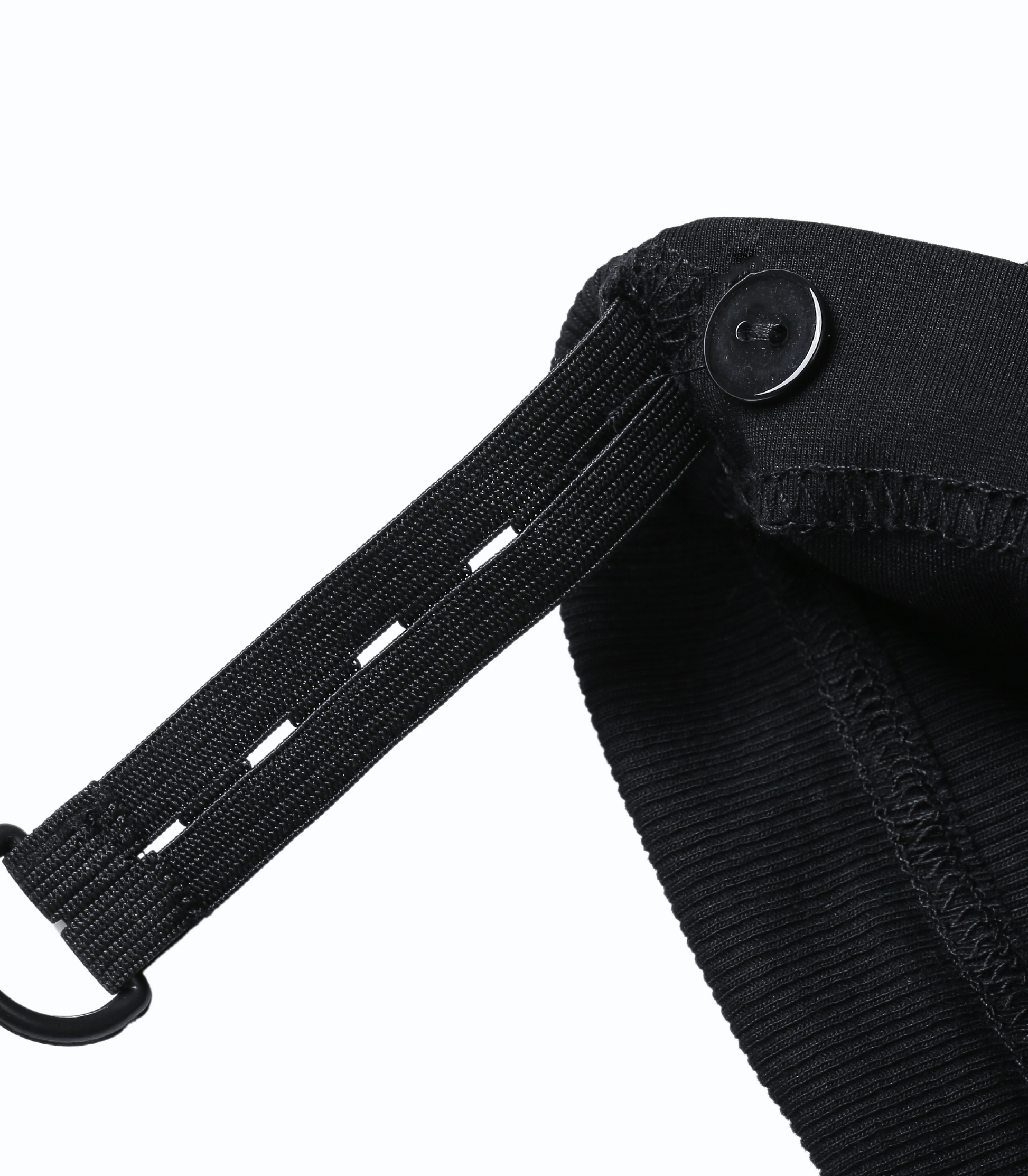 Close-up of a black strap attached to a black bag on a white background