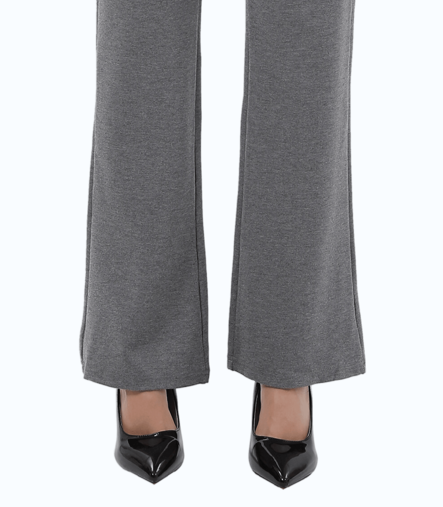 Gray pants worn with black high-heeled shoes on a white background