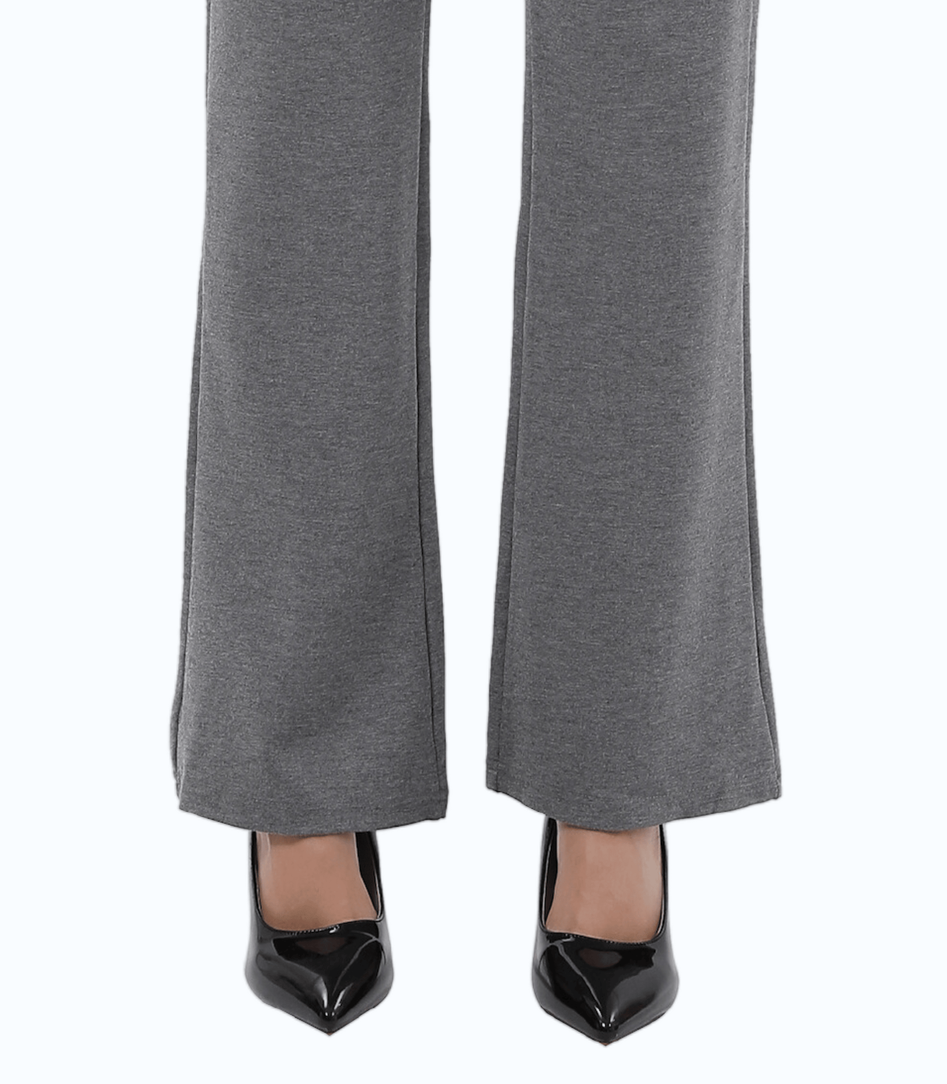 Gray pants worn with black high-heeled shoes on a white background