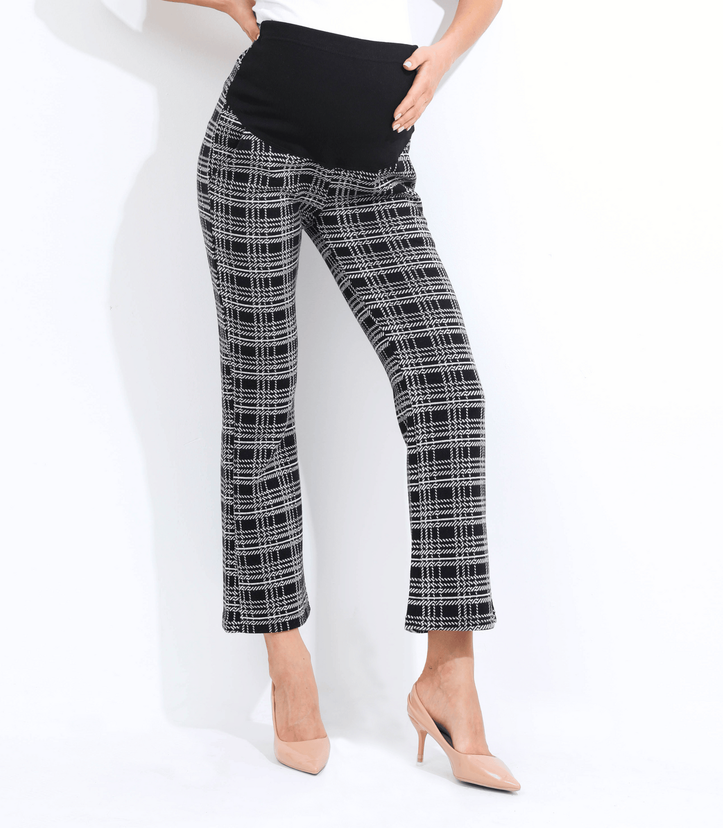 Person wearing black and white plaid pants on a white background