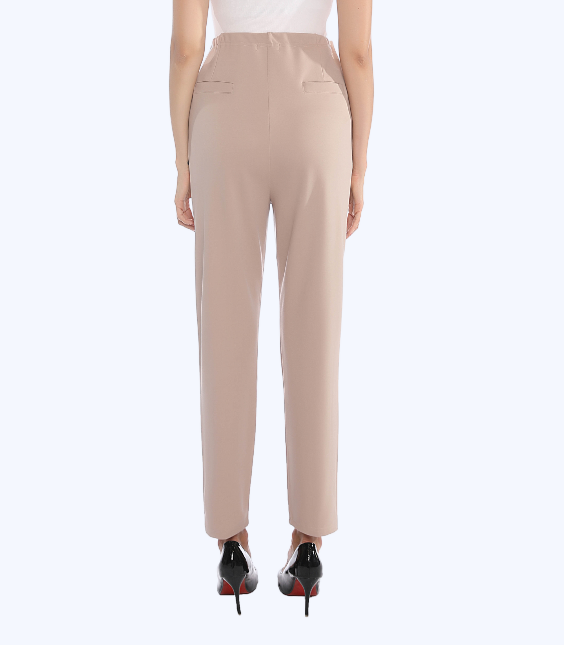 Beige pants worn by a person on a white background