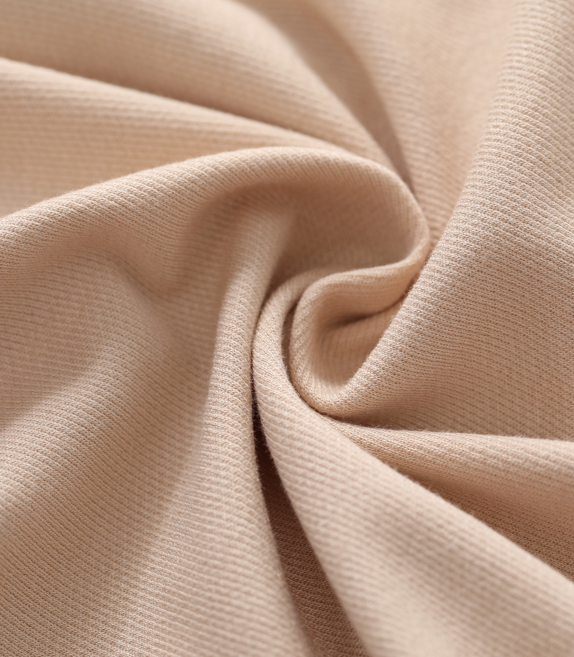 Close-up of beige fabric with folds