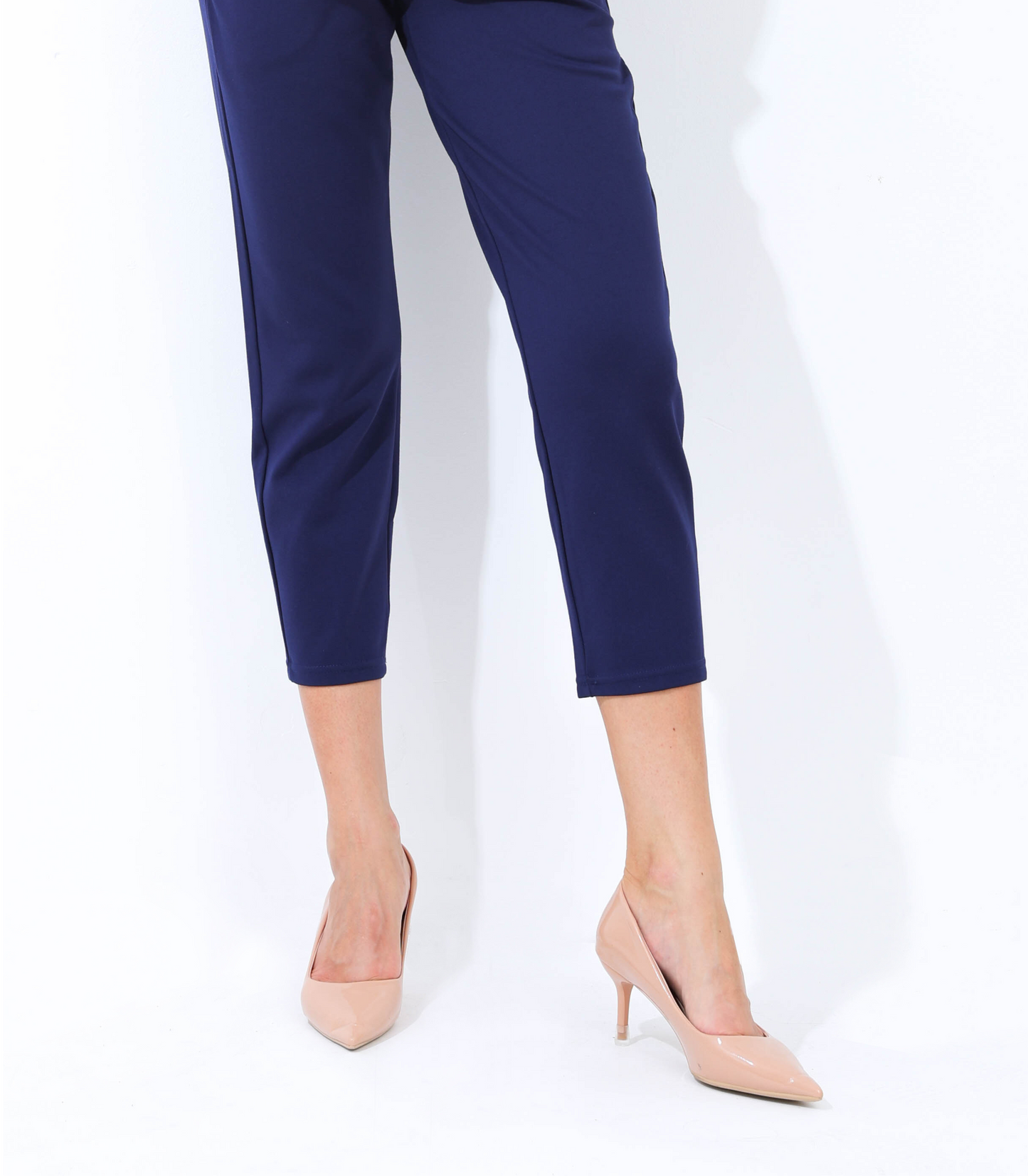 Navy blue pants worn by a person on a white background