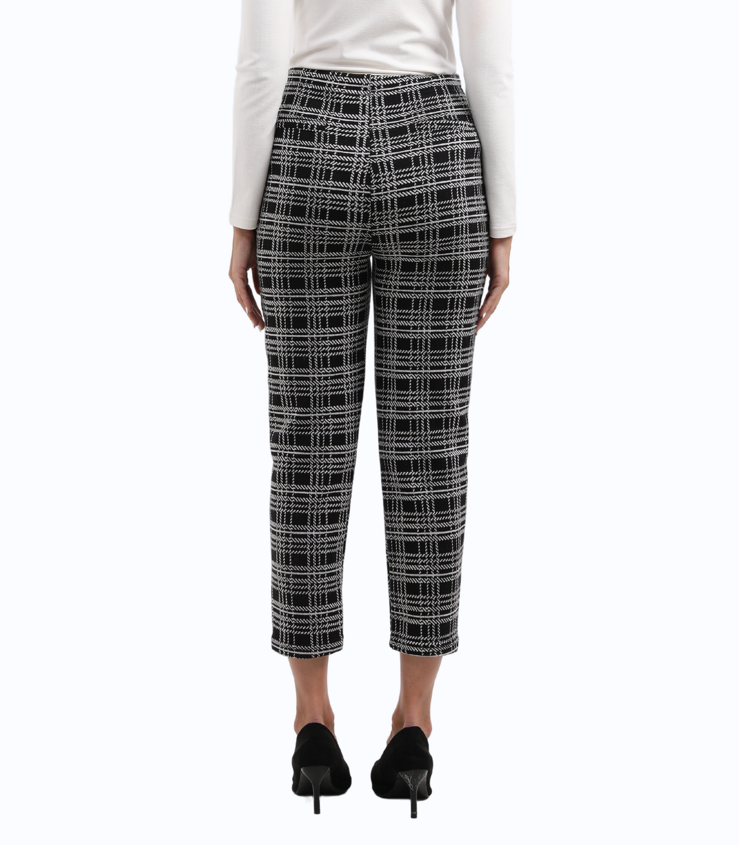 Person wearing black and white checkered pants on a white background