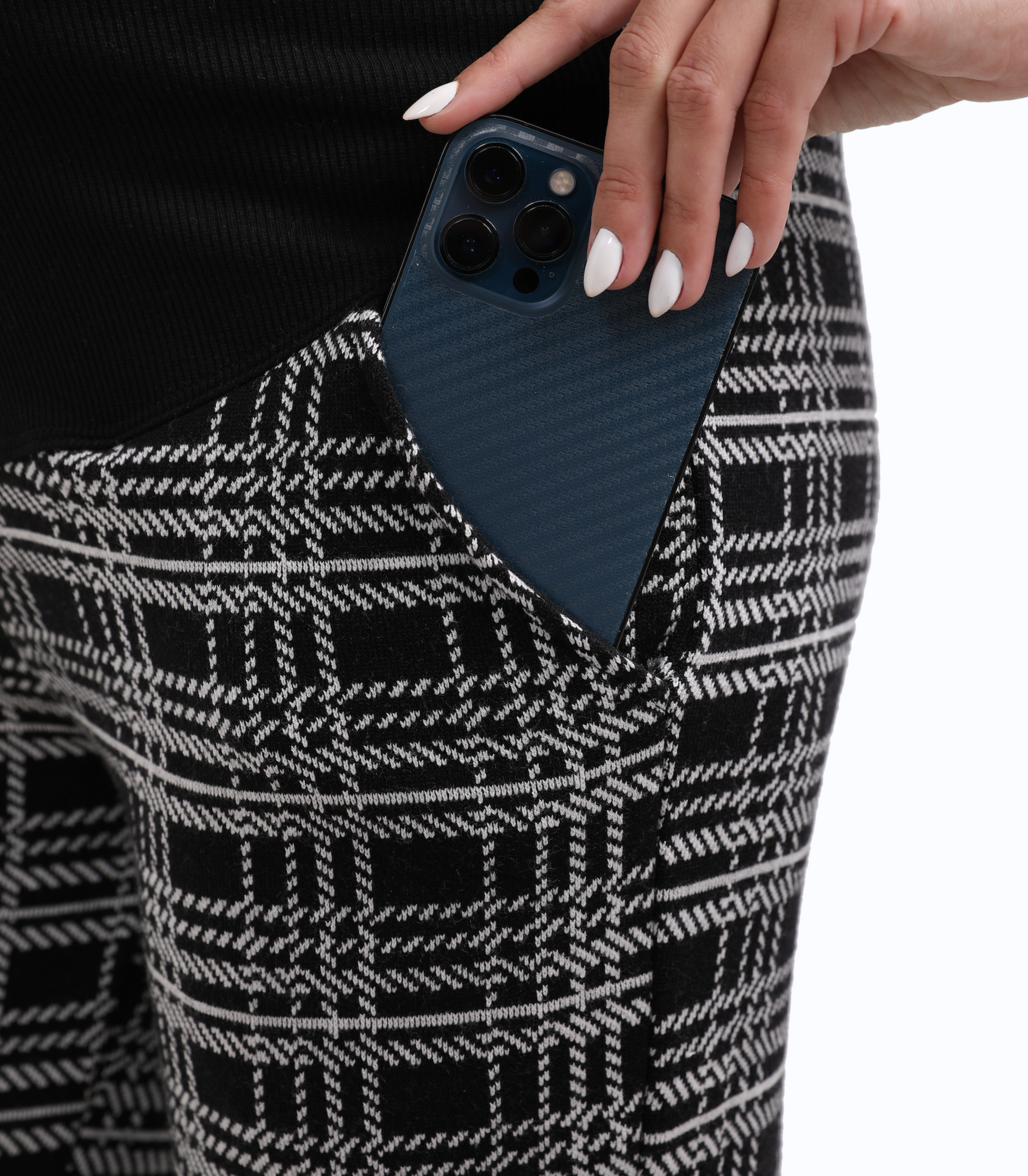 Person holding a phone case against a patterned outfit