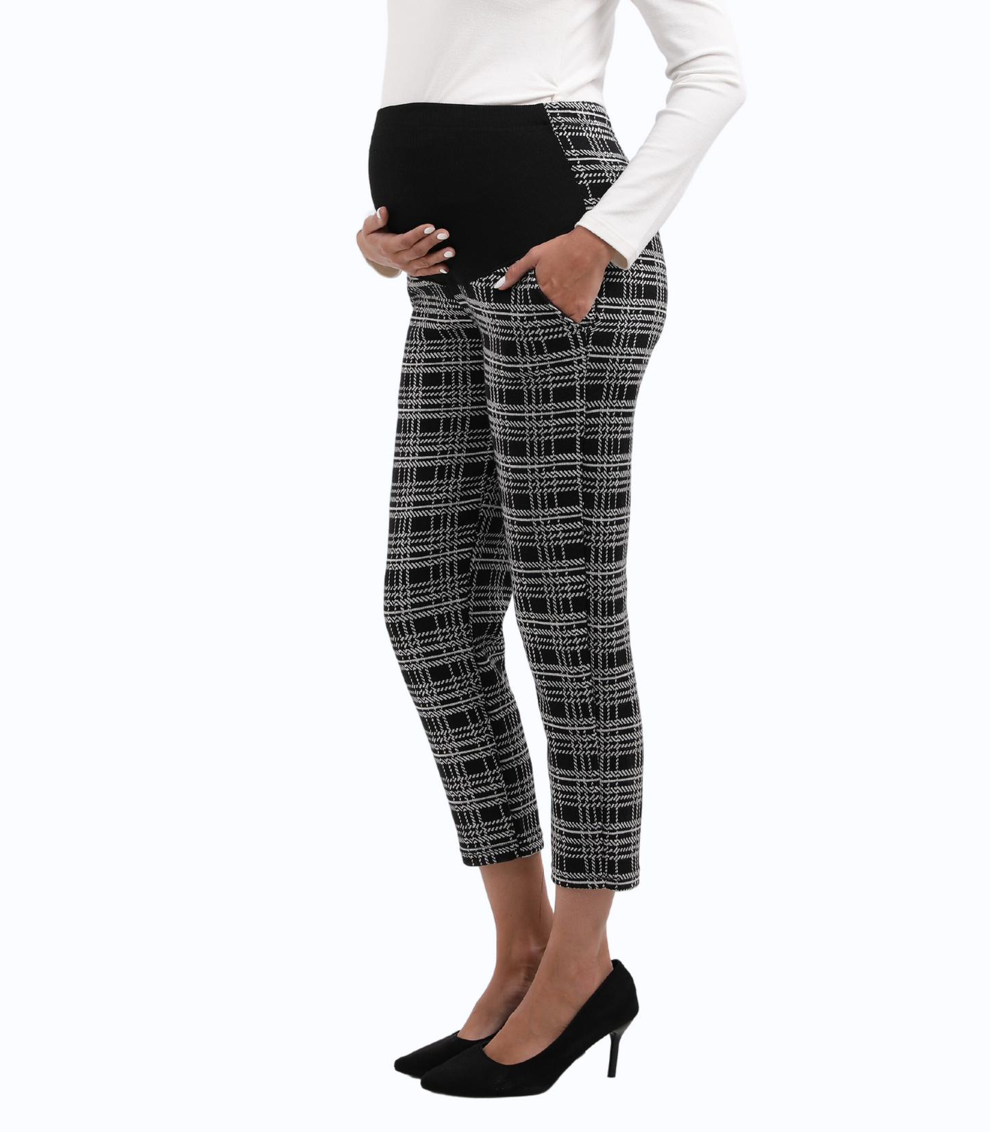 Black and white checkered pants worn by a person on a white background