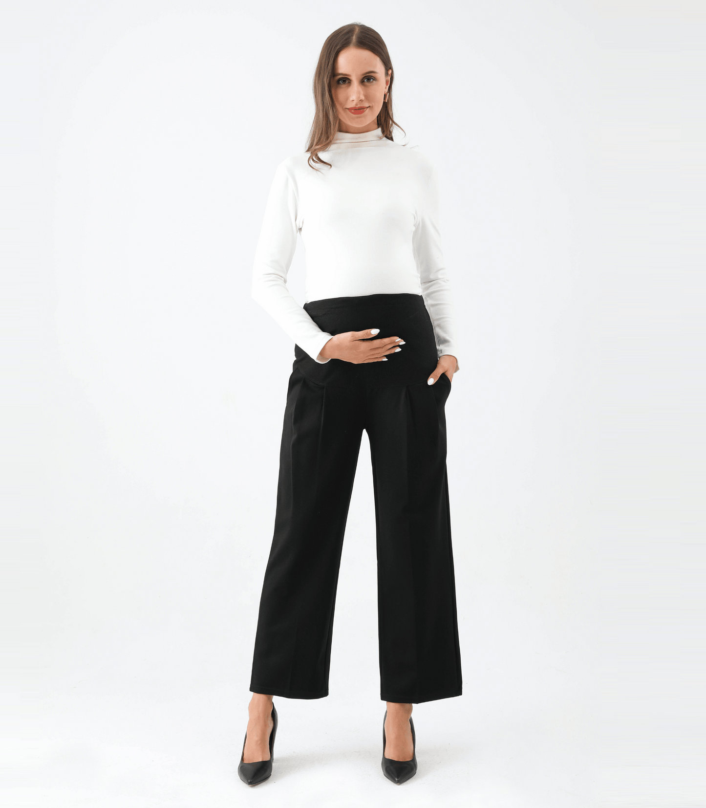 Woman wearing a white top and black wide-leg pants on a white background
